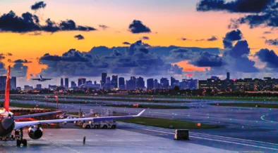 Miami International Airport terminal with solar panels installed on rooftop under sunny blue sky