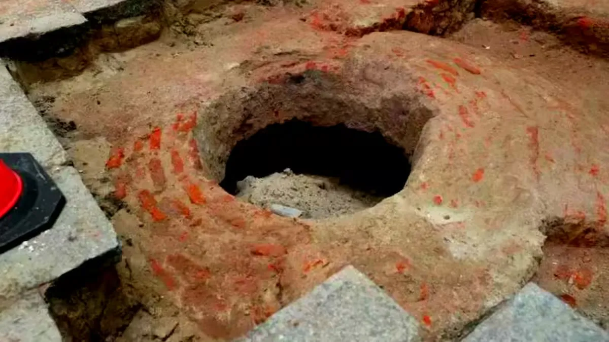 ** Archaeological excavation showing colonial-era stone water well beneath historic Montevideo museum floor