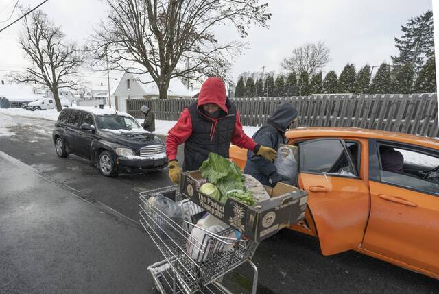 Volunteers Brave Snow and Cold to Feed 200+ Families