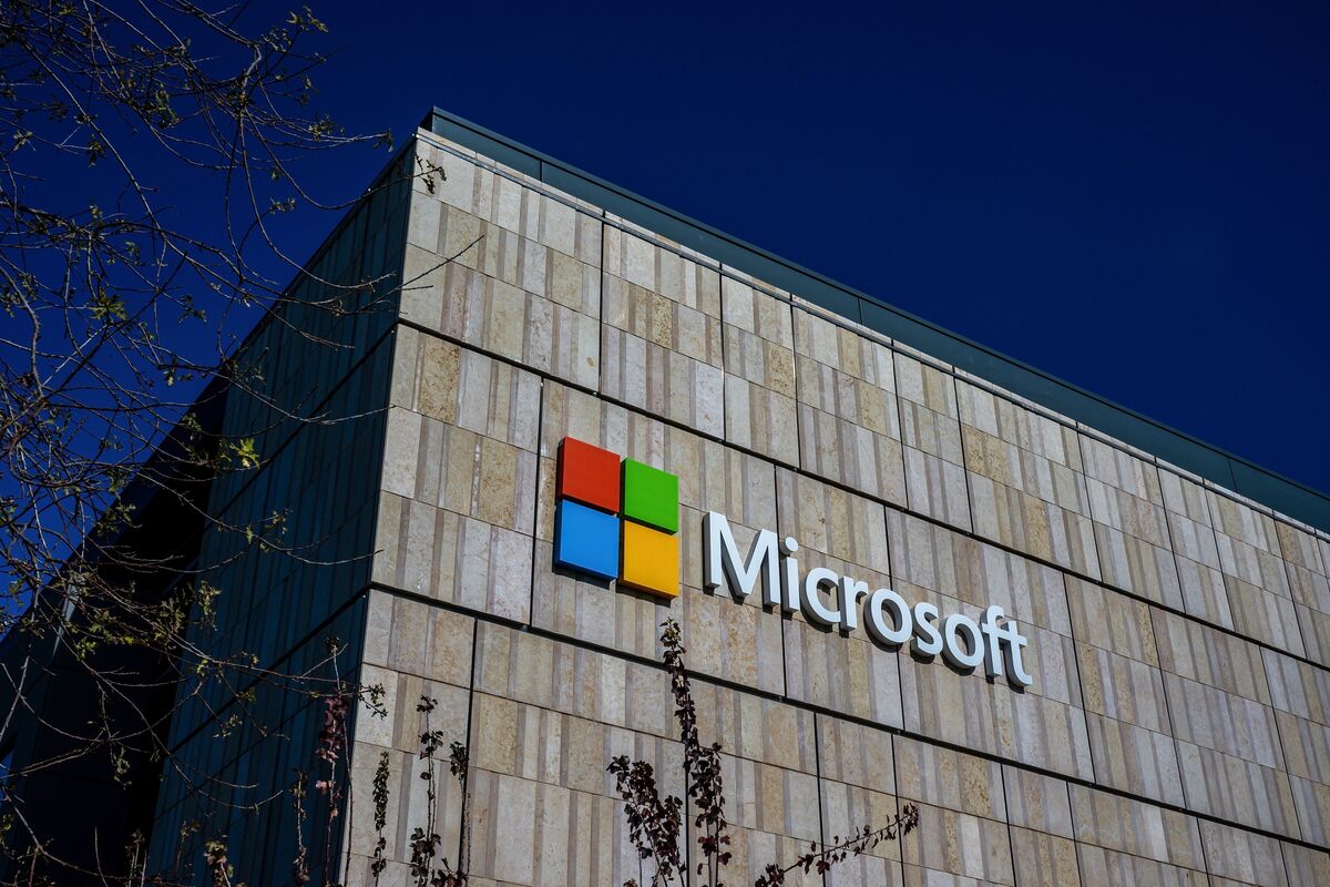 Microsoft logo on modern glass building with Singapore skyline in background