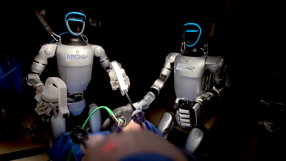 Humanoid robot in medical setting performing teleoperated surgery with surgical instruments attached to arms