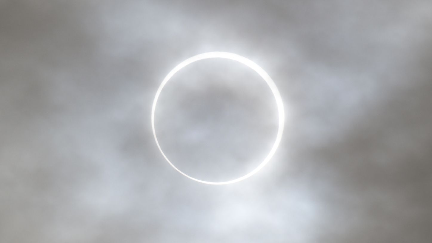 Annular solar eclipse showing moon creating glowing ring of fire effect around sun's outer rim