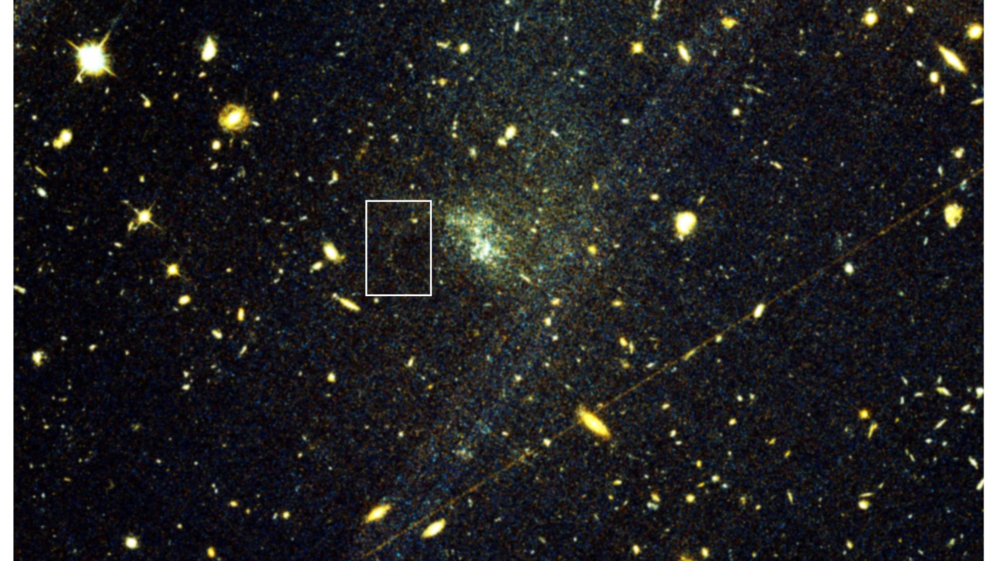 Hubble Space Telescope image showing faint stellar stream trailing from distant dwarf galaxy
