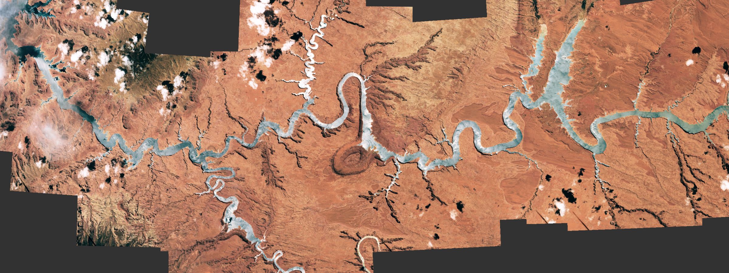 Aerial view of Lake Powell reservoir glowing silver from sunlight reflection in Utah canyon