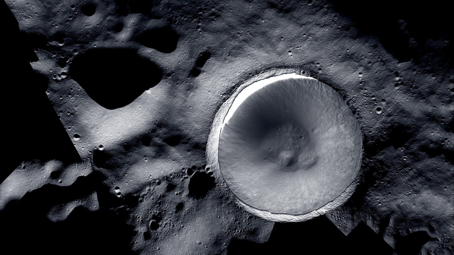 Mosaic image of shadowed Shackleton Crater at the moon's south pole showing ice deposits