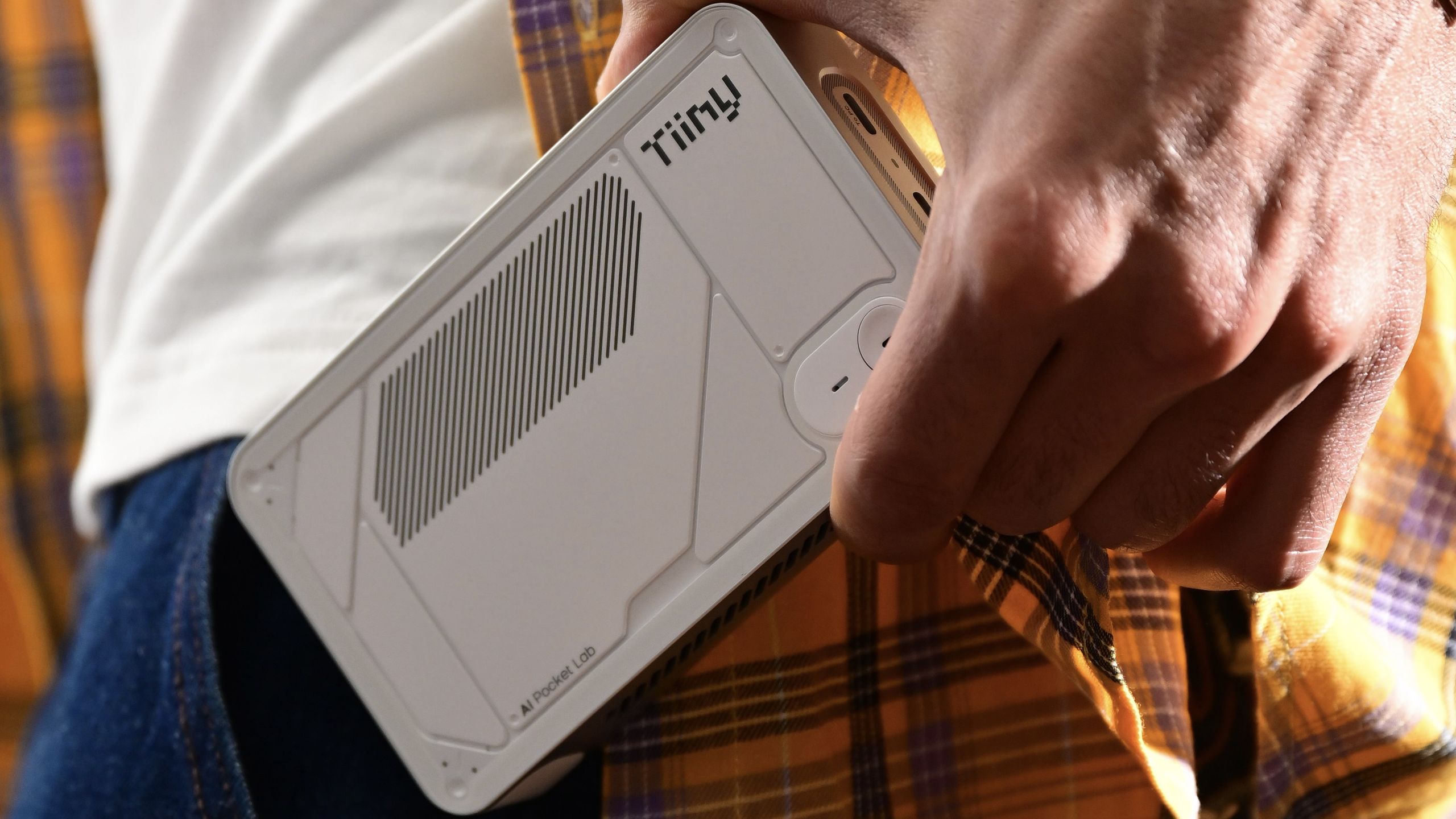 Small black rectangular AI supercomputer device that fits in a human hand
