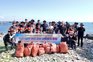 Korea Zinc employees and Ulsan city officials pose together after beach cleanup event in South Korea