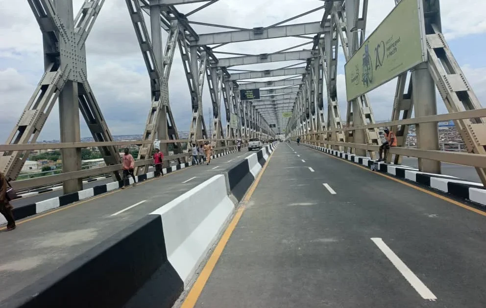 Historic First Niger Bridge spanning water between Nigerian states, newly repaired with fresh road surface