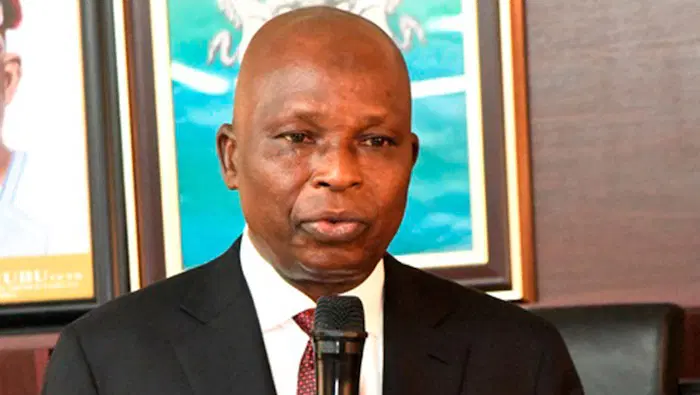 Nigerian government officials celebrating legal victory in modern office setting