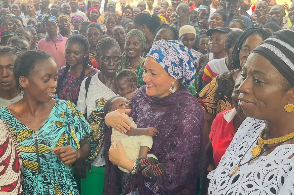 UN Deputy Secretary-General Dr. Amina Mohammed holding newborn baby during community visit in Benue State Nigeria