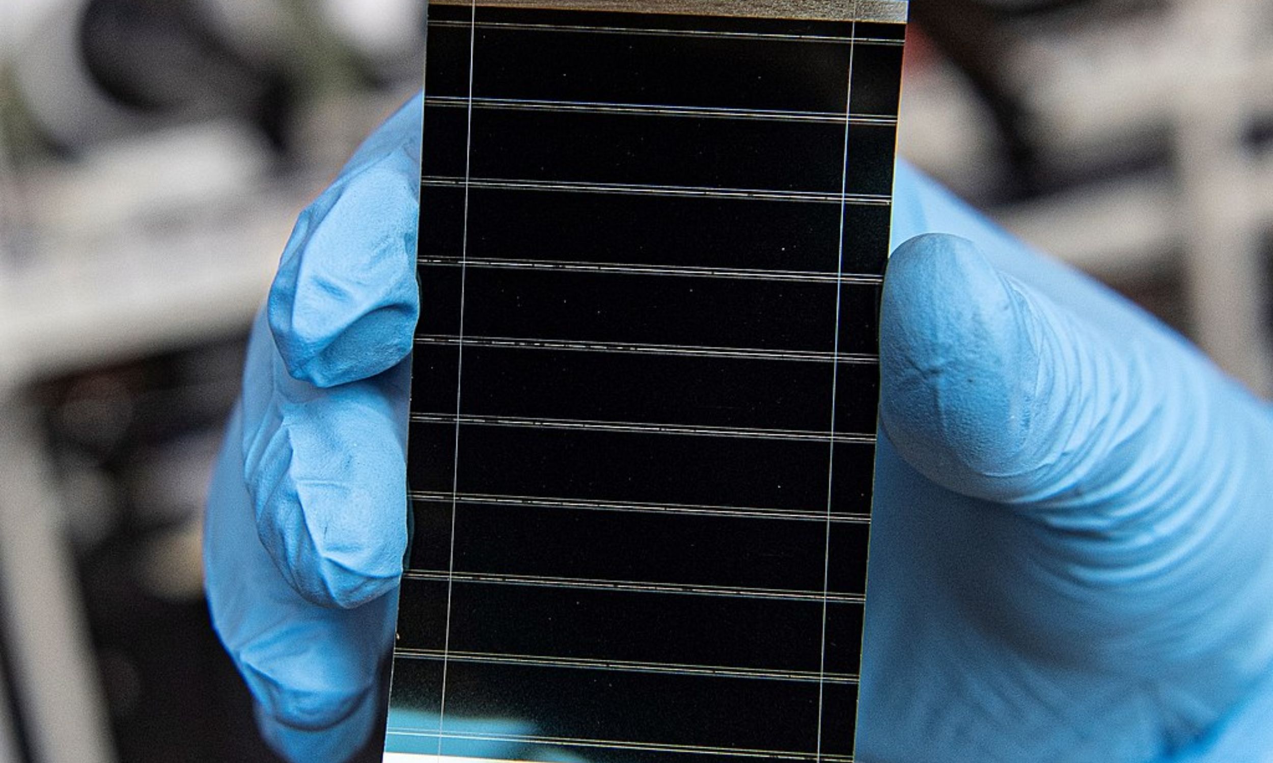 Large industrial solar panels arranged in rows reflecting bright sunlight on clear day