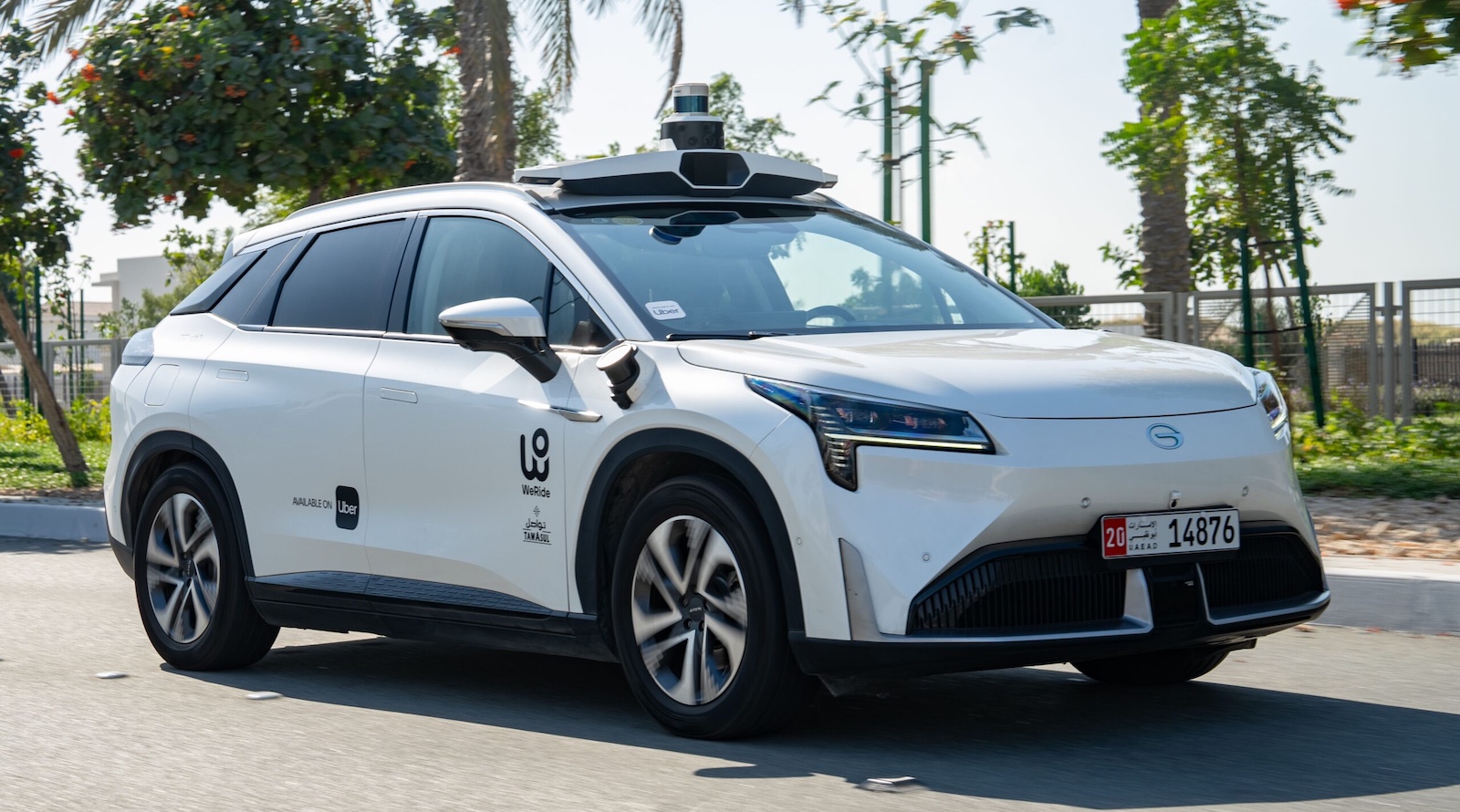 Electric vehicle charging station with autonomous robotaxi plugged in at urban location
