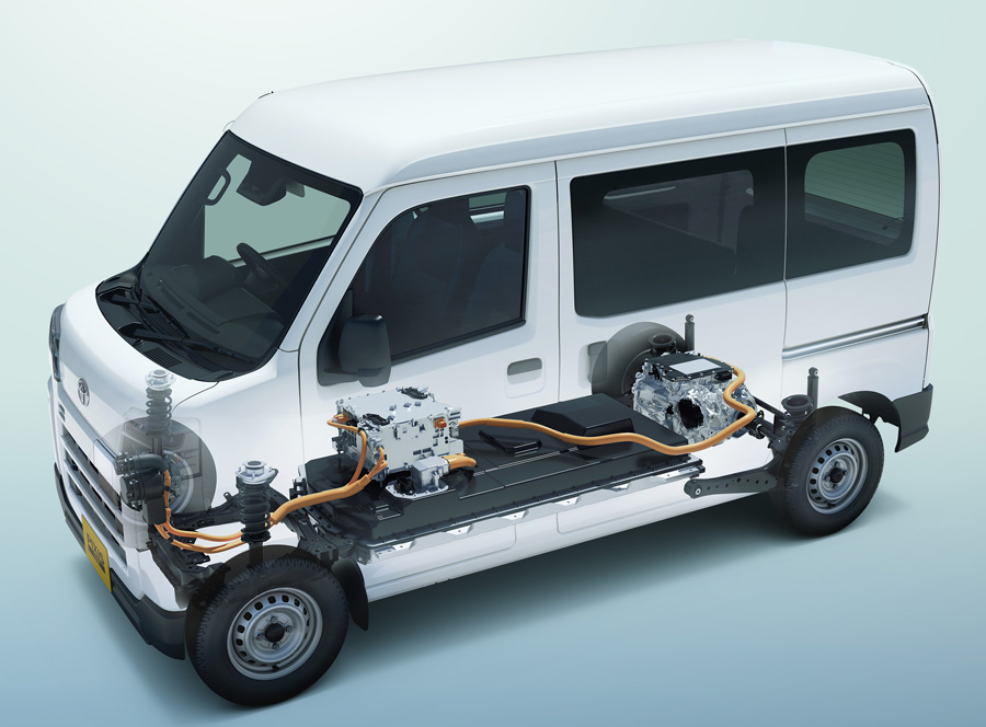 White Toyota and Daihatsu electric delivery vans parked side by side in Japan