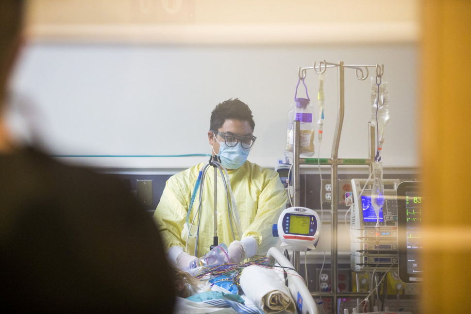 Diverse group of medical professionals reviewing ethical guidelines document together in hospital setting