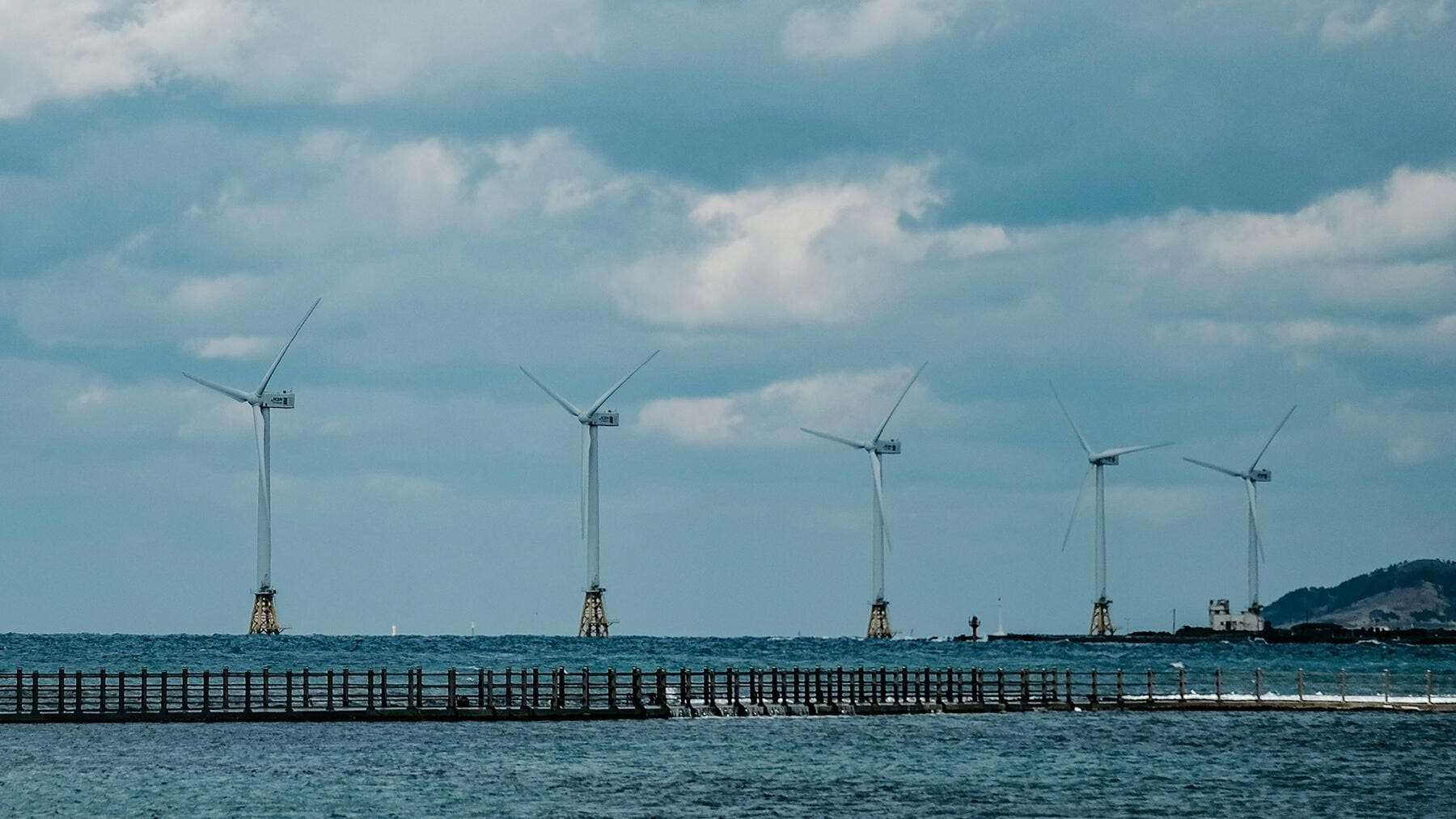 Offshore wind turbines rising from ocean waters generating renewable electricity for Poland