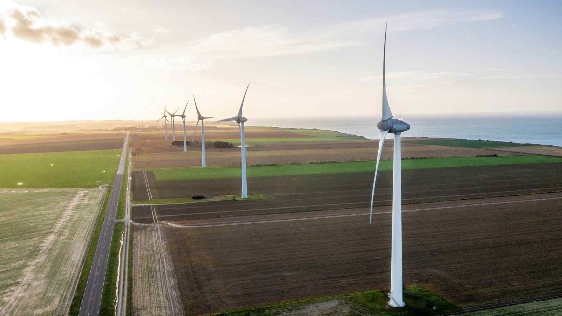 Modern white wind turbines generating clean renewable energy across German countryside landscape