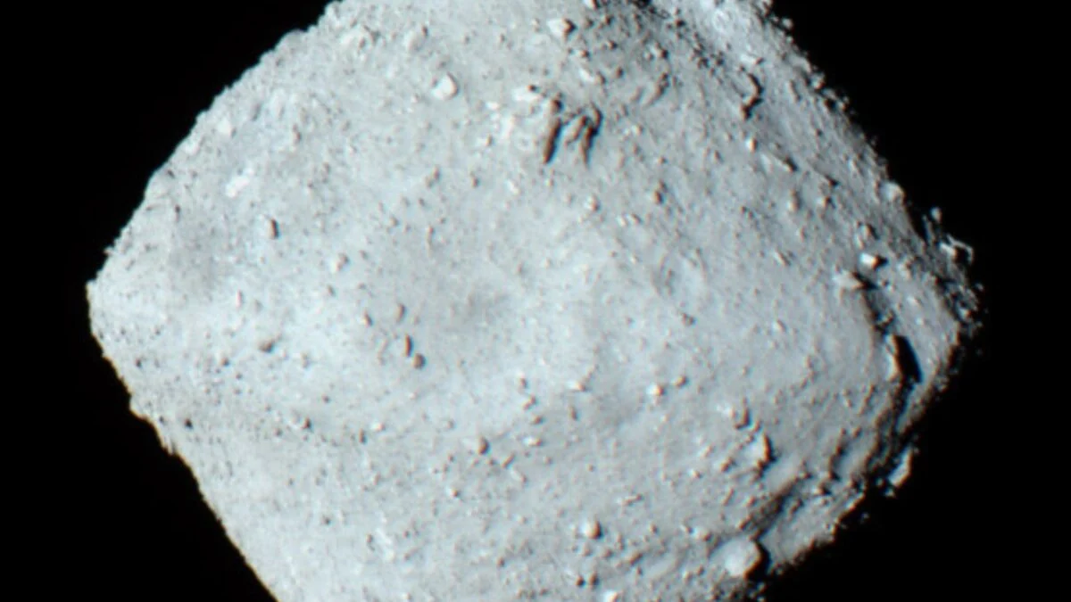 Microscope image of dark rocky samples collected from asteroid Ryugu by spacecraft