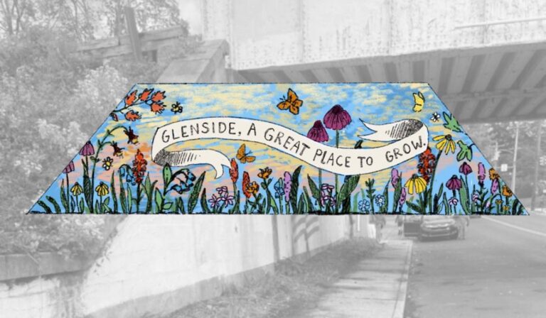 Community volunteers painting colorful mural on railway bridge in Glenside Pennsylvania