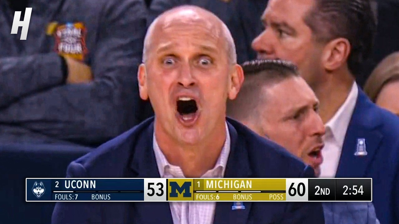 Michigan Wolverines basketball team celebrating their 2026 NCAA national championship victory with trophy
