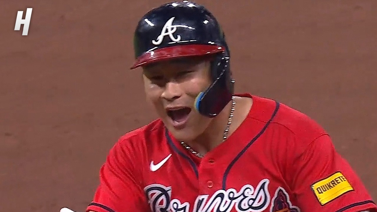 ** Atlanta Braves players celebrating walk-off victory on baseball field in extra innings