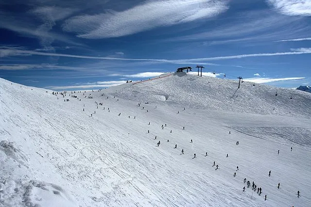 British Winter Olympic athletes competing in freestyle skiing and snowboarding events in snowy mountain conditions