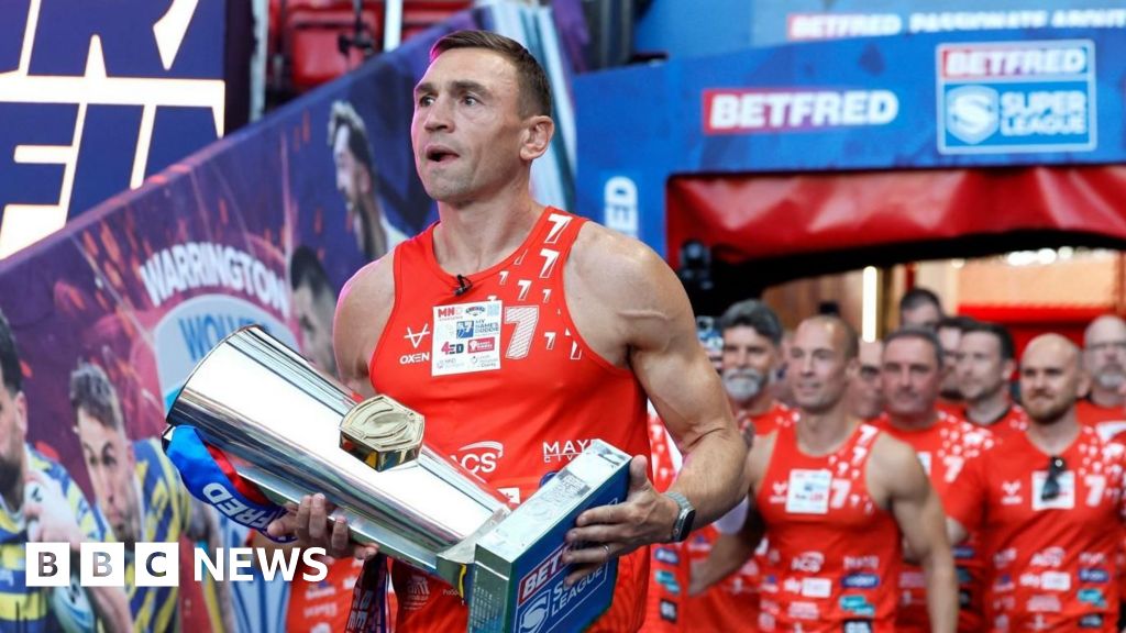 Kevin Sinfield carrying Super League trophy into Old Trafford Stadium after completing ultramarathon challenge