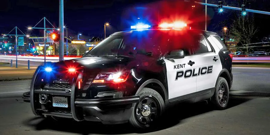 Kent Police patrol vehicle with emergency lights, representing first responders helping unconscious woman