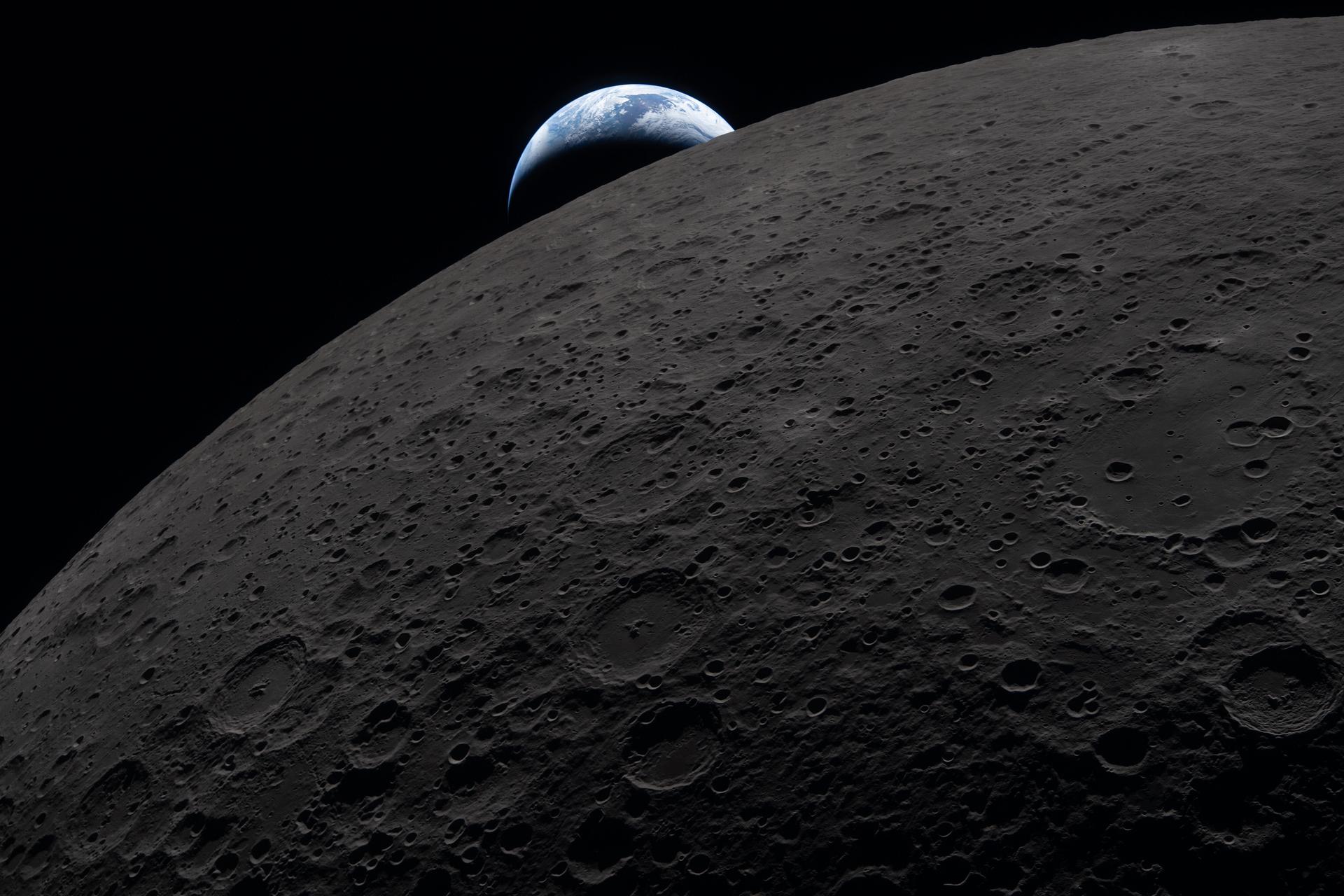 Blue Earth setting behind gray cratered lunar surface viewed through Orion spacecraft window during Artemis II mission