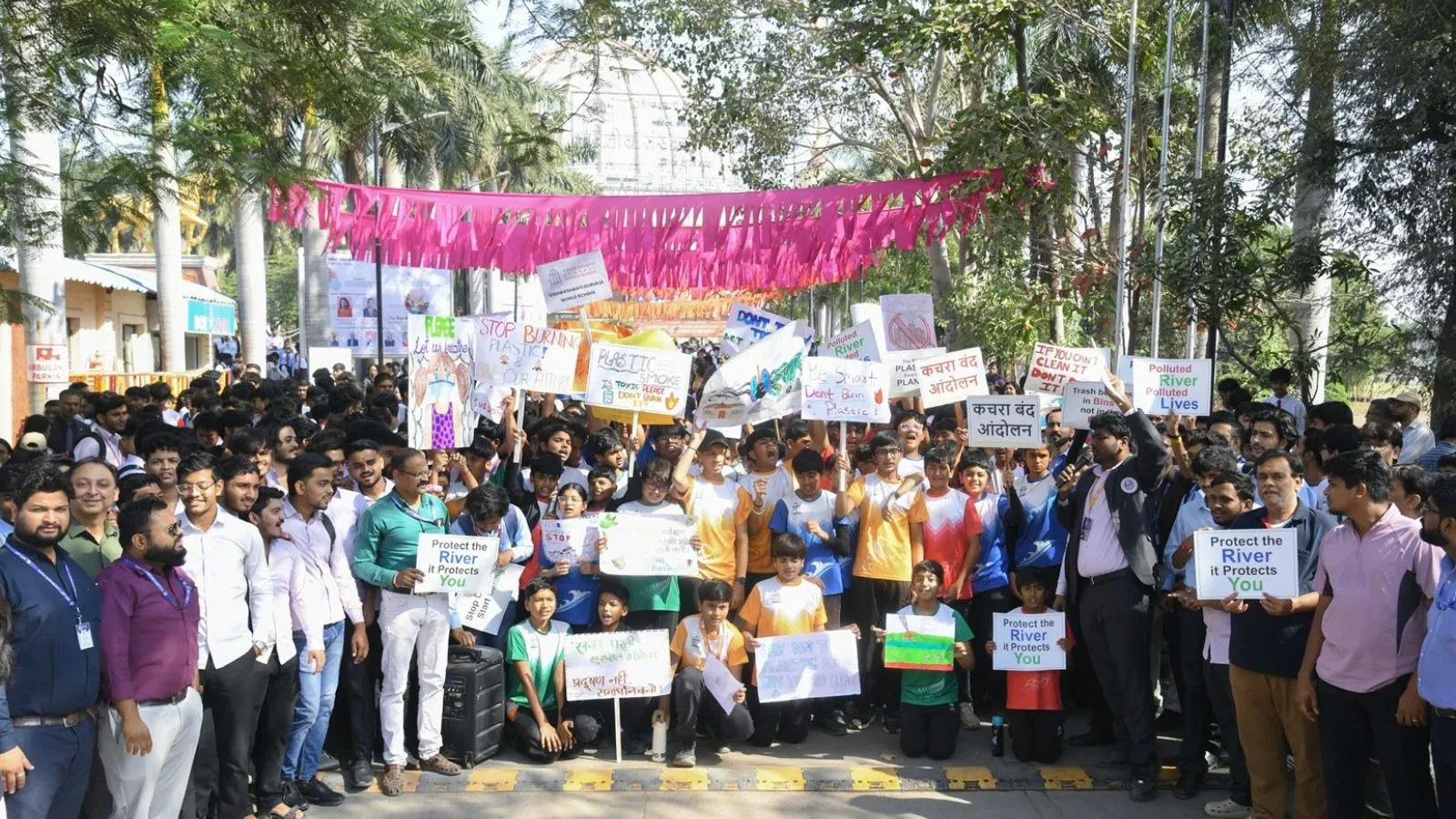 MIT ADT University students holding protest signs demanding end to illegal riverbed waste dumping