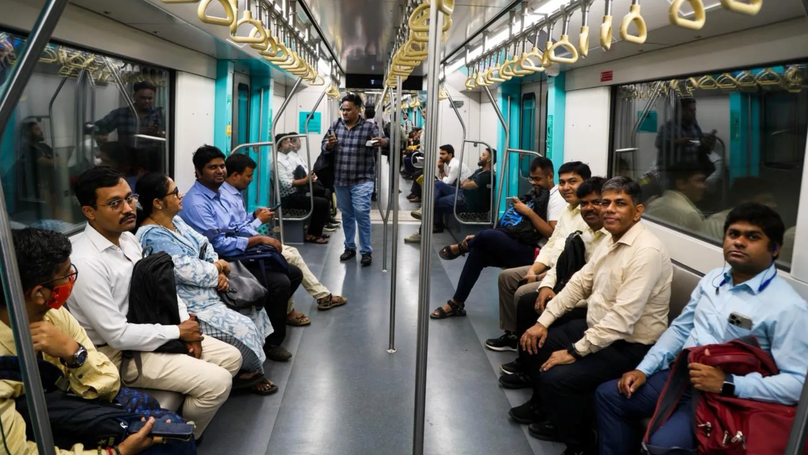 Modern Mumbai metro train traveling through elevated tracks in busy urban area
