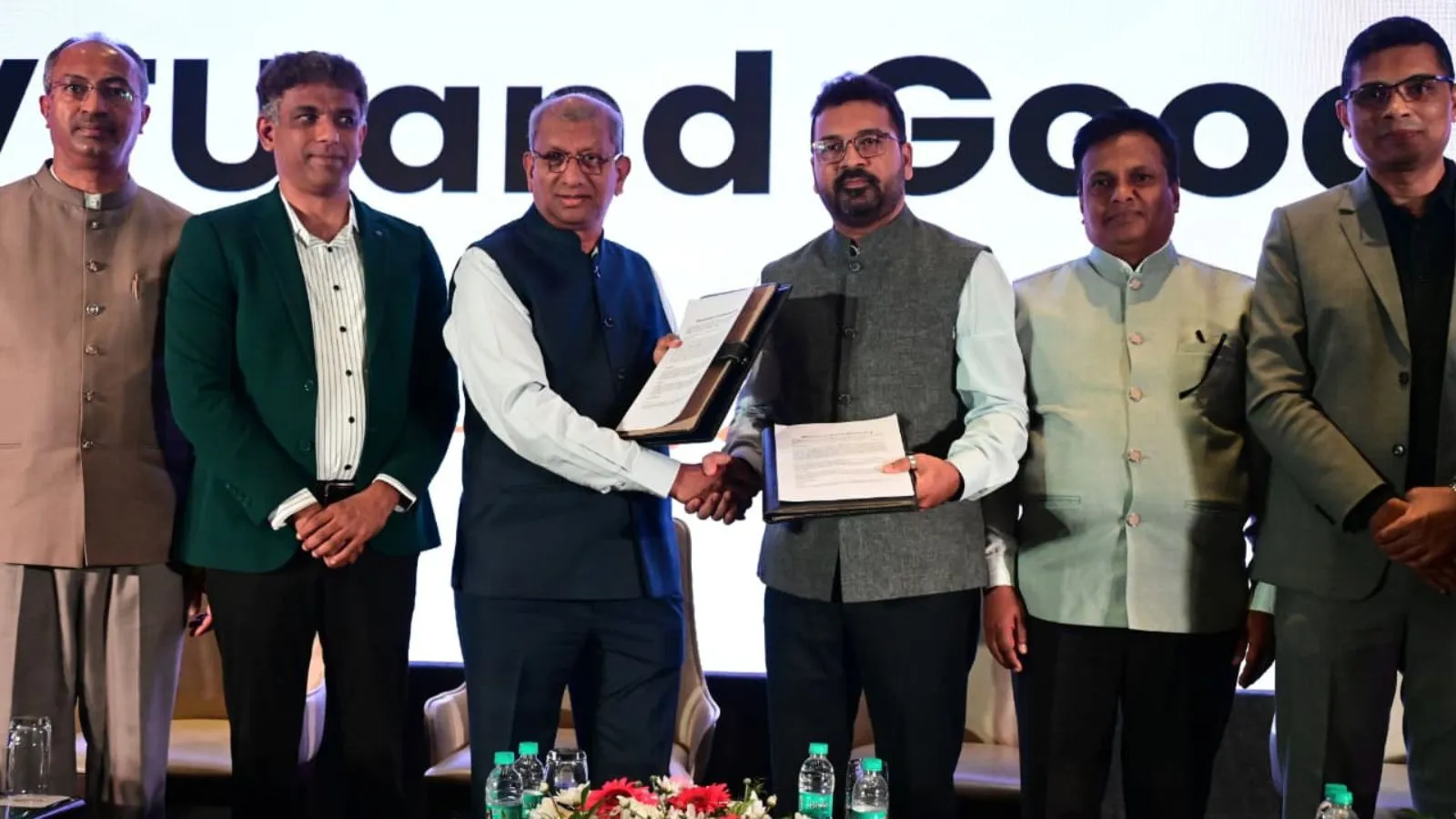 University officials signing partnership agreement at desk in Bengaluru with Google and VTU representatives