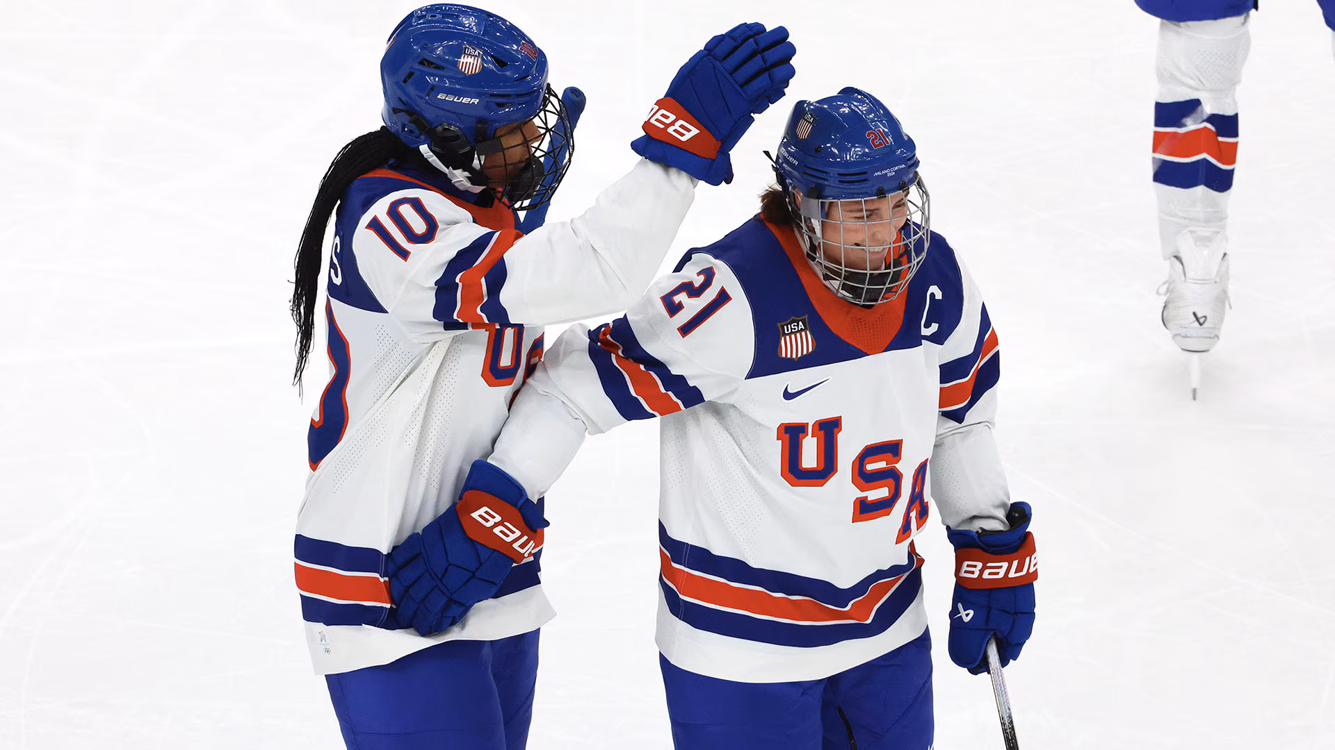 Team USA women's hockey players celebrating historic 5-0 shutout victory over Canada at 2026 Olympics