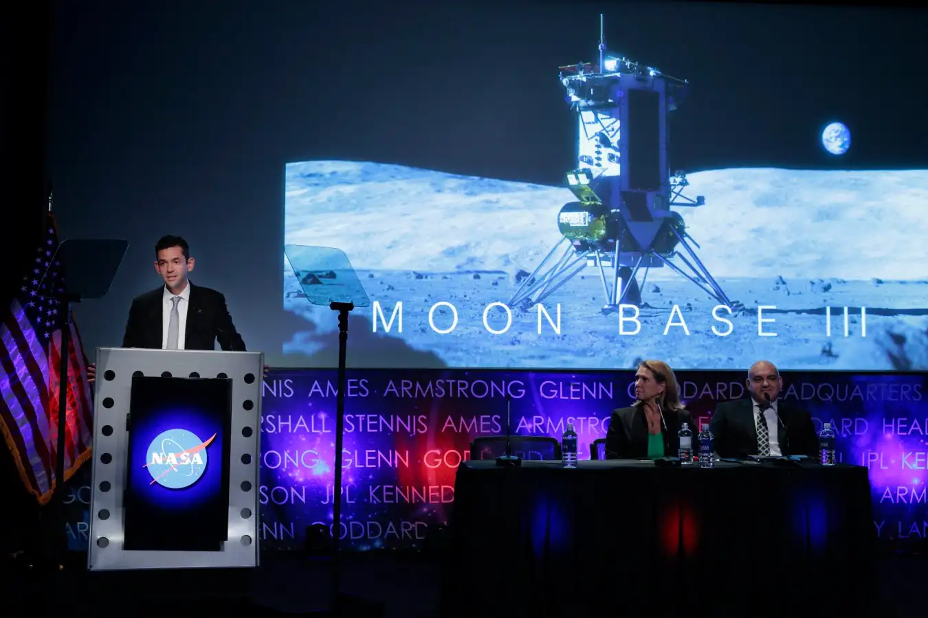 Artist illustration showing astronauts, rovers, and cargo operations at planned lunar base near moon's south pole