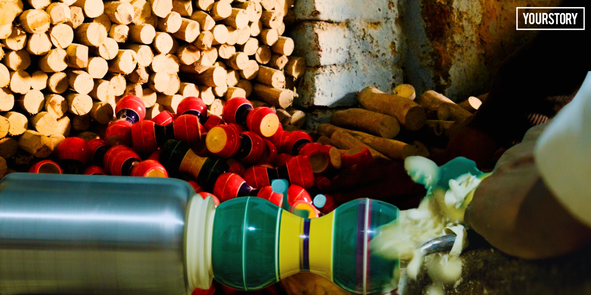 Indian artisan shaping colorful wooden spinning top on traditional motor-powered lathe