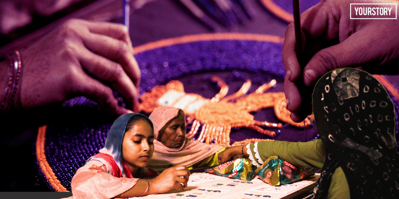 Indian woman embroidering metallic zari threads on fabric stretched across wooden frame at home
