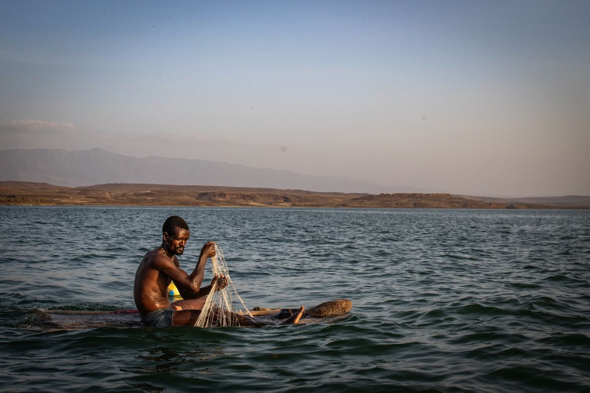 Ikal Angelei standing near Lake Turkana in northern Kenya, advocating for Indigenous communities