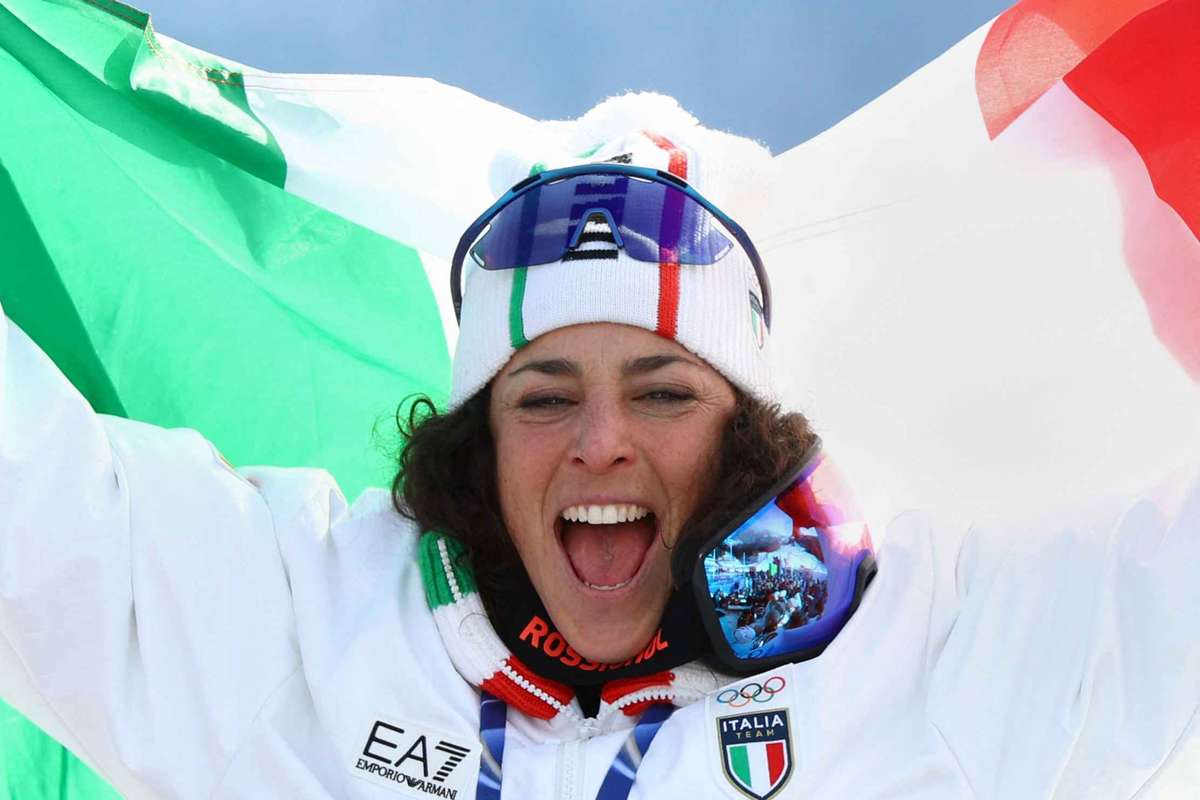 Federica Brignone celebrates with arms raised after winning Olympic super-G gold medal in Italy