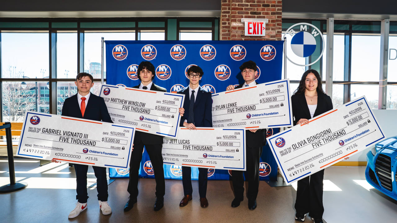 Five high school hockey players in formal attire holding oversized scholarship checks from New York Islanders