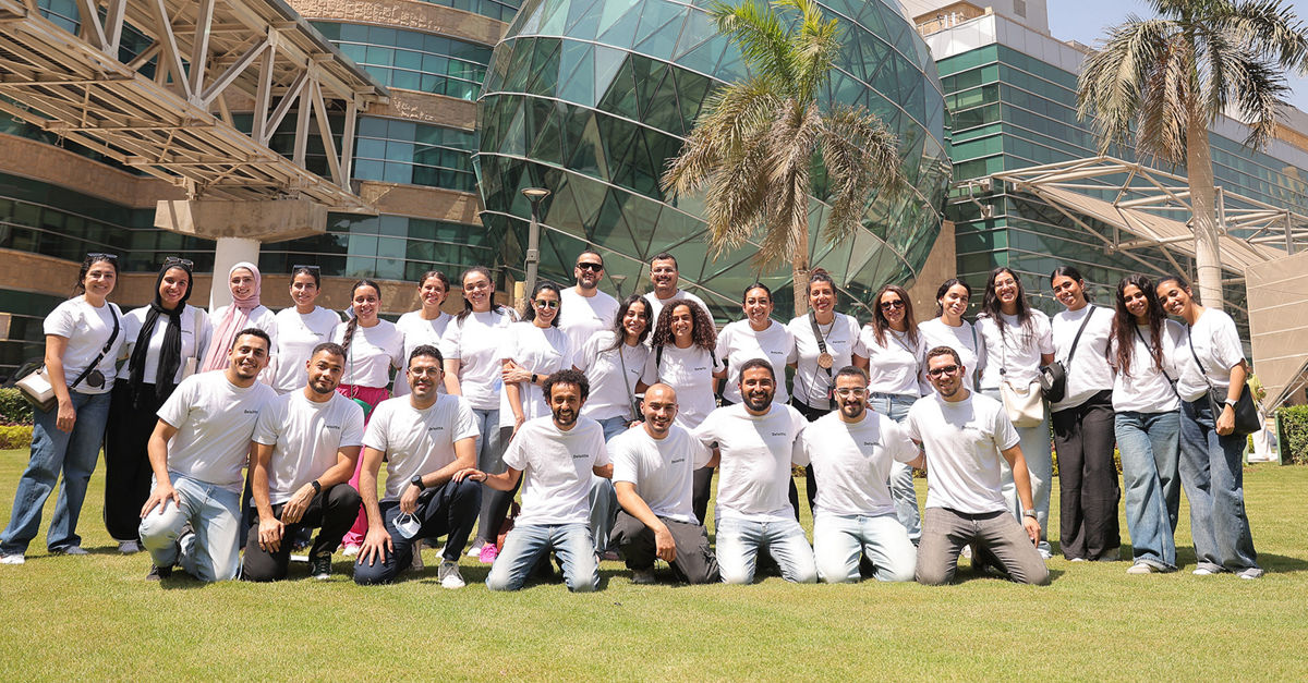 Young professionals collaborating at computers in modern Cairo innovation center office space