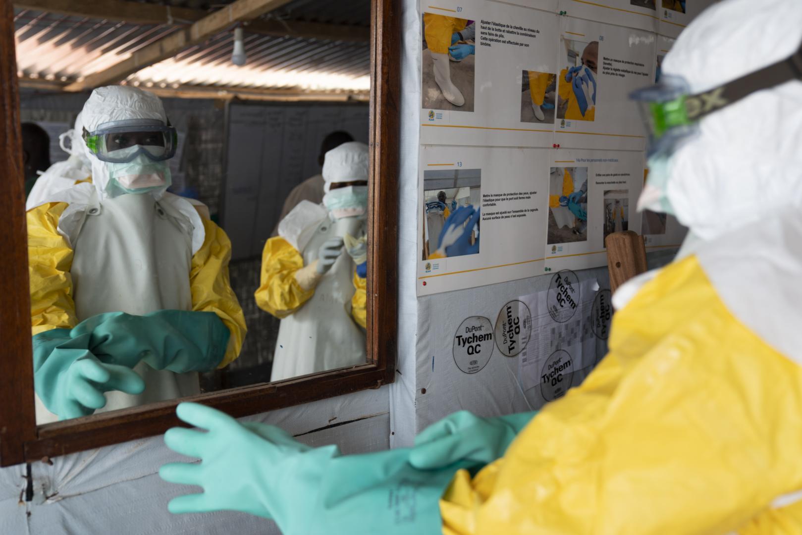 Healthcare workers in protective equipment celebrating Uganda's successful containment of Ebola outbreak