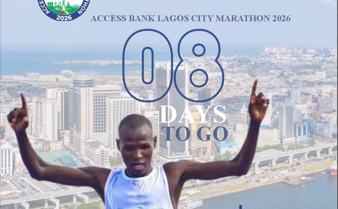 Runners competing in the Lagos City Marathon on a city street with crowds cheering