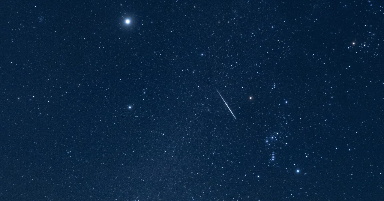 Bright meteor streaking across dark night sky during Orionid meteor shower captured by NASA camera