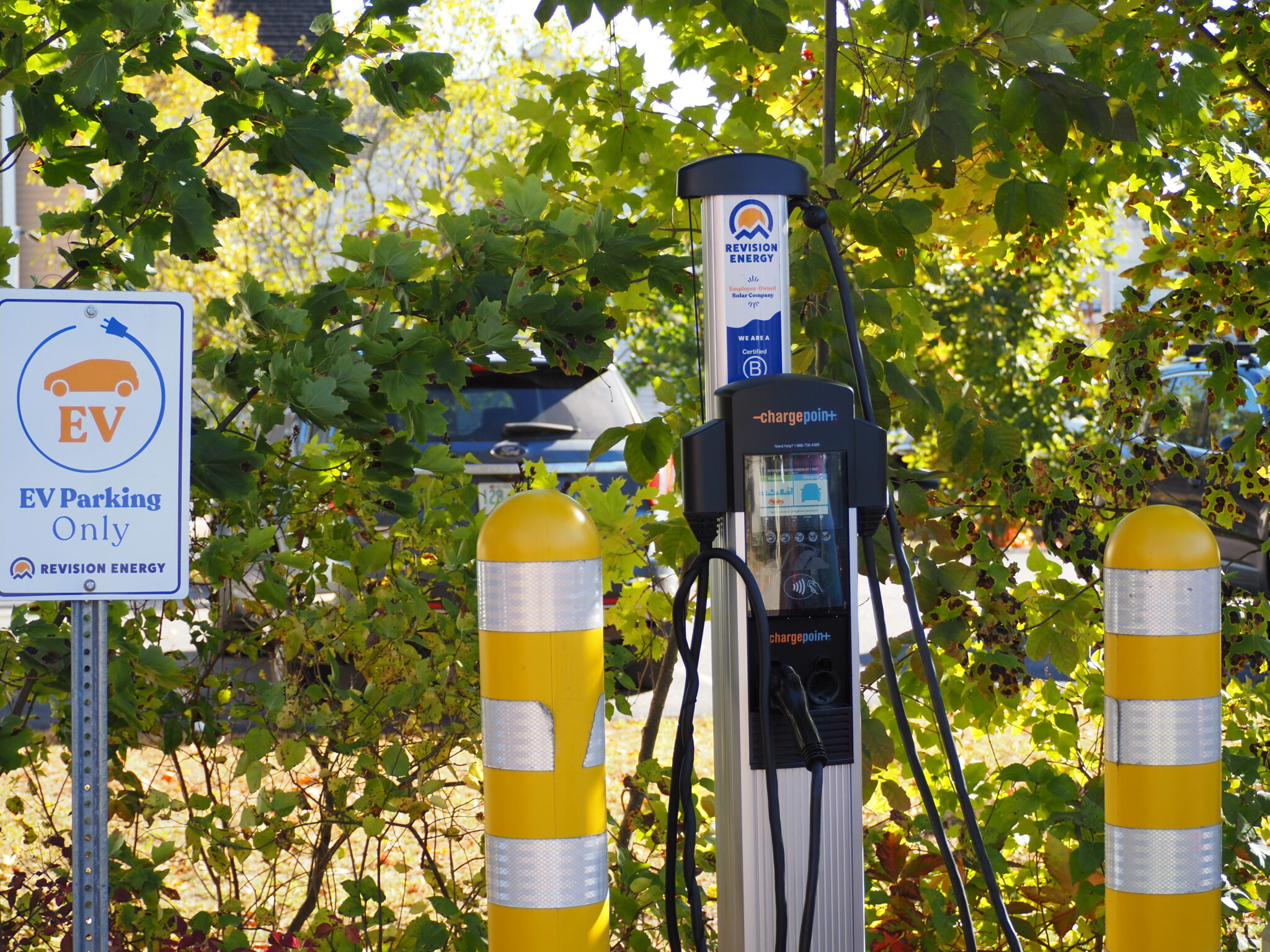 Electric vehicle charging station at scenic New Hampshire tourist destination with mountains in background