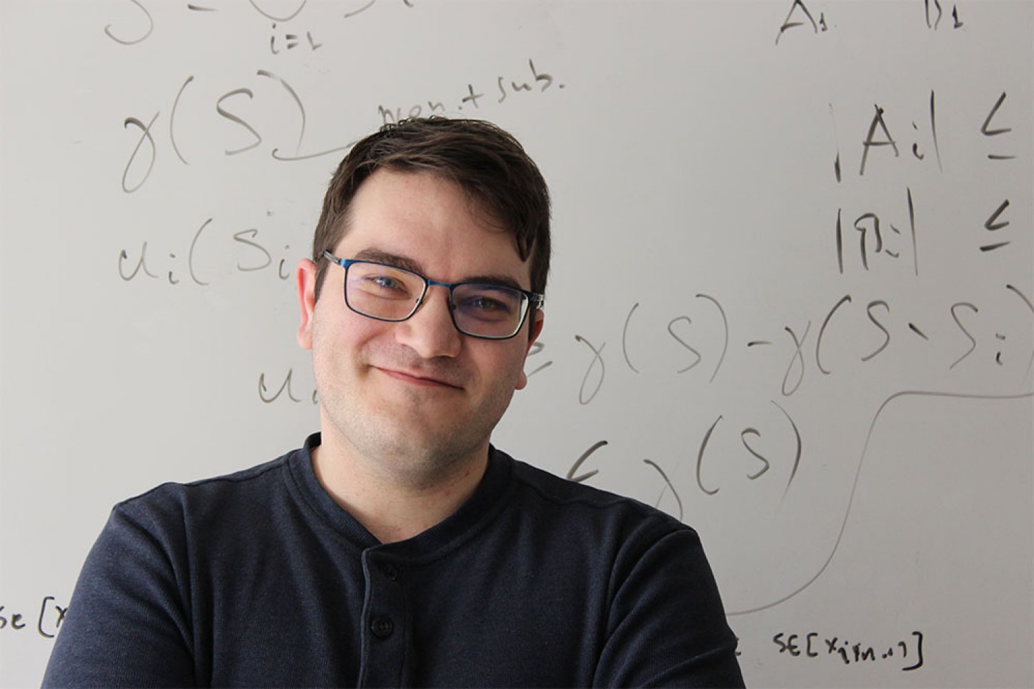 MIT Professor Gabriele Farina standing in laboratory, researching artificial intelligence and game theory applications