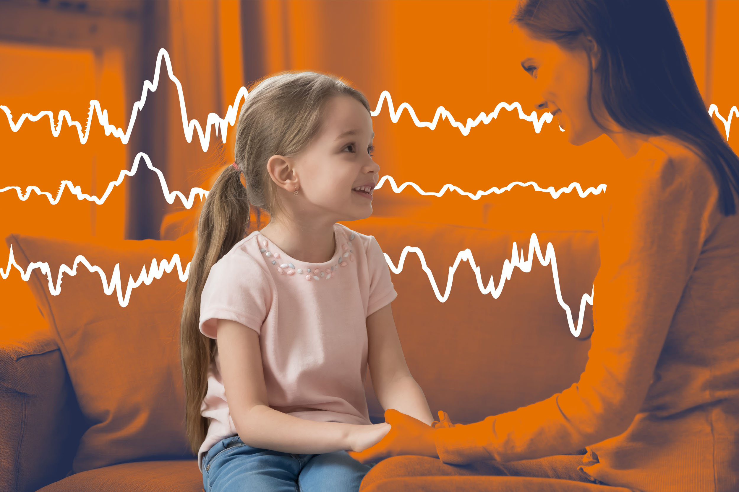 Child wearing EEG cap with sensors while researchers monitor brain activity during listening exercise