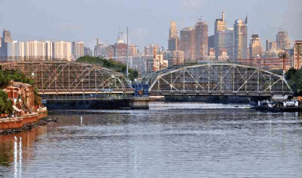 Solar-powered floating interceptor system collecting plastic waste from urban river in Manila, Philippines