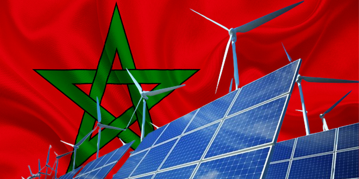 Solar panels and wind turbines spanning Morocco's desert landscape under bright blue sky