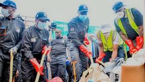 Waste management trucks and workers collecting garbage during Lagos monthly environmental sanitation day