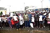 Nigerian community members receiving bags of rice from Dangote Foundation representatives during food distribution ceremony