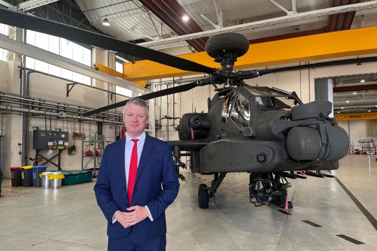 British Army Apache attack helicopter on display at Middle Wallop Army Aviation Centre with maintenance crew